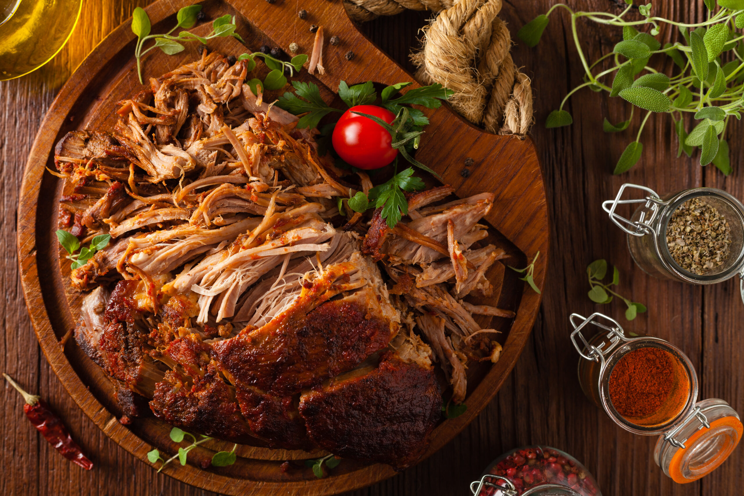 Pulled pork on a wooden board. Top view.